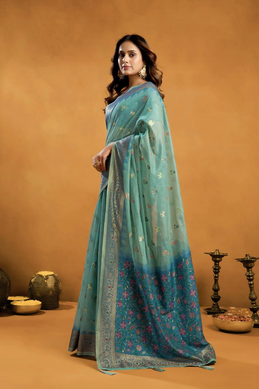 Woman wearing a teal saree with a subtle pattern against an orange background